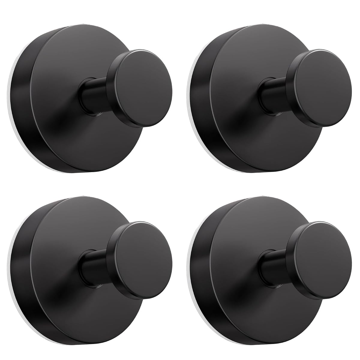 Quatre crochets noirs à ventouse fixés sur un mur carrelé clair dans une salle de bain